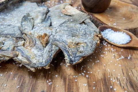 Dried and salted cod heads with skin and scales Stock Photos