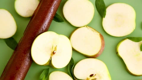 Dried apple fruit snack with mint leaves on green background Stock Footage 345336763