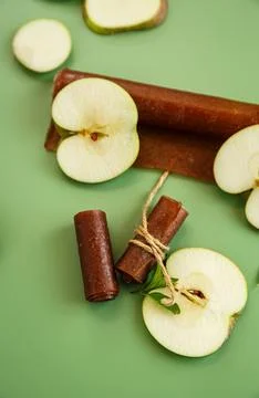 Dried apple fruit snack with mint leaves on green background Stock Photos