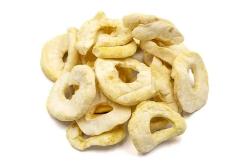 Dried apple slice isolated on white background. Dried fruit in sunlight. clos Stock Photos