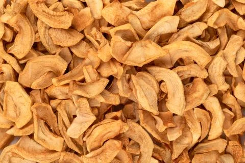 Dried apples or apple chips as an abstract background. Stock Photos