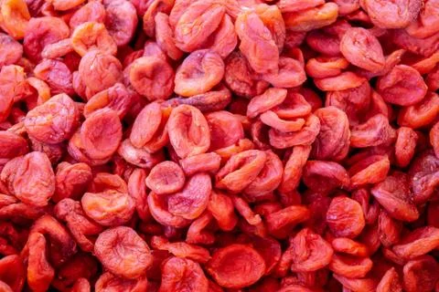 Dried apricot fruit on sun pattern background. Organic natural dried apricots Stock Photos
