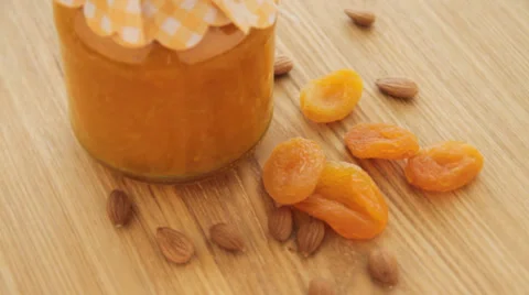 Dried apricot with nuts and jam rotate on wood plate Stock Footage 37148567