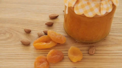 Dried apricot with nuts and jam turn on wood background Stock Footage 37148687