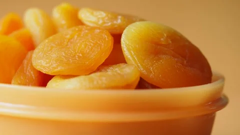 Dried apricots in a bowl on a simple background Stock Footage 340544722