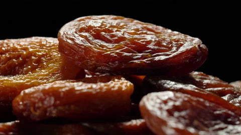 Dried apricots close up on black background. Video stock 154452326