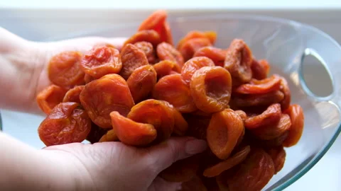Dried apricots close-up. Dry raw apricot fruit food. Top view bowl. Delicious Stock Footage 302095723