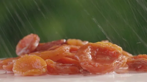 Dried apricots close-up under running water slow mo Stock Footage 146696583