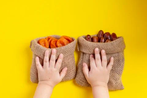 Dried apricots fruit and dates in canvas bags. Healthy nutrition concept Stock Photos