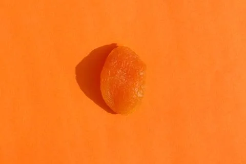 Dried apricots with a hard shadow on a colored background pattern Stock-Fotos