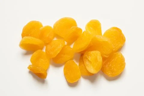 Dried apricots lying on a white surface, close-up, dried fruit Stock Photos