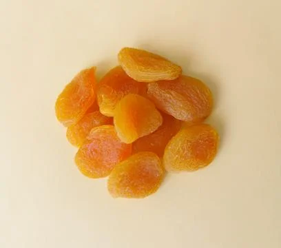 Dried apricots on a yellow background Stock Photos