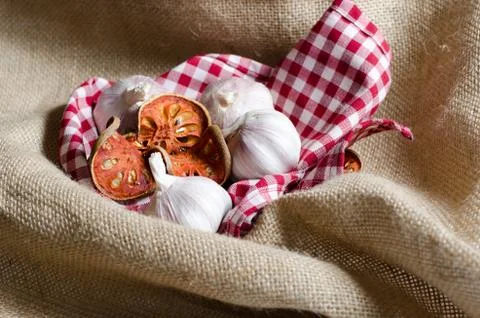 Dried bael tea put on red scott cover by vintage burlap. Stock Photos