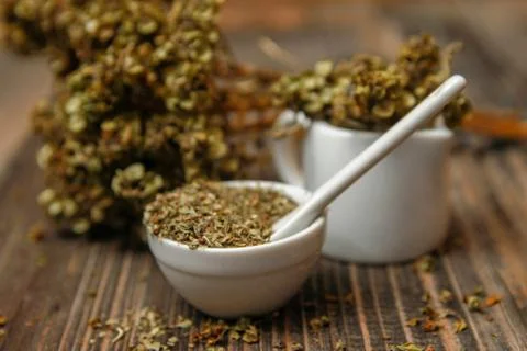Dried basil spice in a small ceramic bowl Stock Photos
