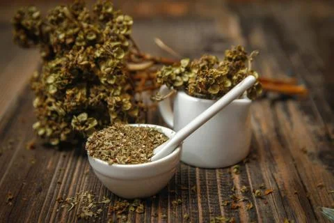 Dried basil spice in a small ceramic bowl Stock Photos