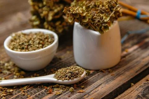 Dried basil spice in a small ceramic bowl Stock Photos