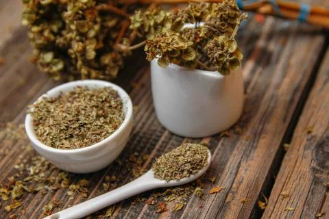 Dried basil spice in a small ceramic bowl Stock Photos