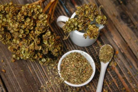 Dried basil spice in a small ceramic bowl Stock Photos