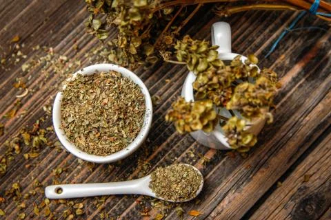 Dried basil spice in a small ceramic bowl Stock Photos