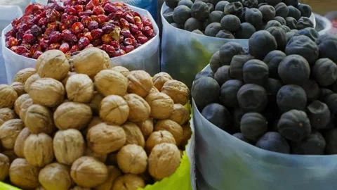 Dried berries, seeds, nuts displayed in white bowls at market stall Stock Footage 344995128
