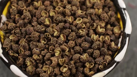 Dried black pepper rotating top view. A bunch of natural black pepper peas hot Stock Footage 256164807