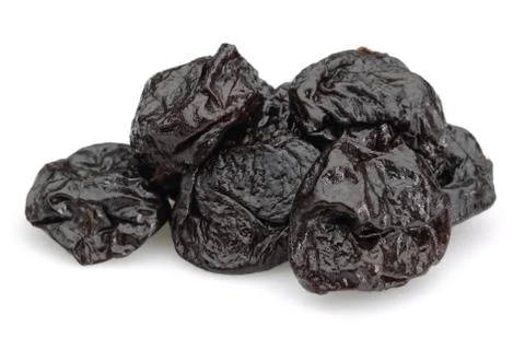 Dried black plums on white background Stock Photos
