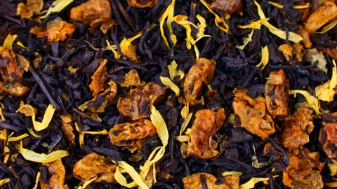 Dried black tea blend with flowers and sea buckthorn berries circle rotation Stock Footage 306044699