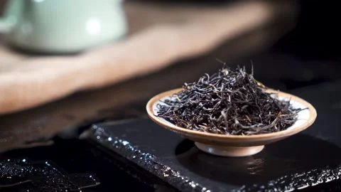 Dried Black Tea Leaves on Ceramic Saucer Moody Still Life Stock Footage 341926112