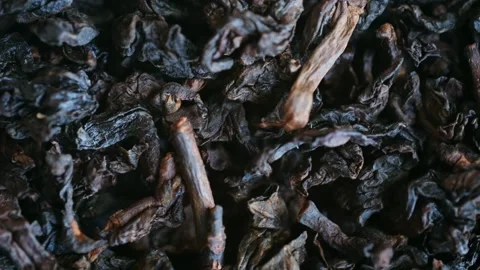 Dried black tea leaves rotating macro close up Stock Footage 337830732