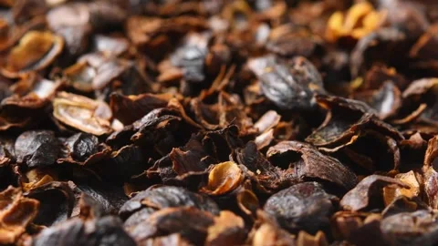 Dried cascara coffee cherry husks rotate in macro close up to show texture for Stock Footage 346200747
