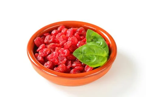 Dried cherries in small earthenware dish Stock Photos