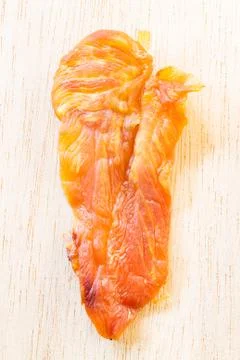 Dried chicken jerky for dogs on wooden background Stock Photos