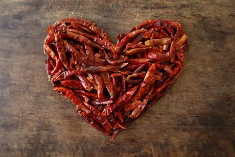 Dried chilli heart shape on a rustic wooden table Stock Photos