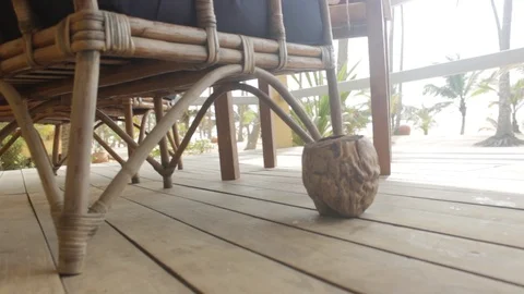 Dried Coconut Fruit and a Cane Chair at Beach Holiday Resort Stock Footage 111249039