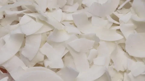 Dried coconut slice close-up, rotation in circle. dried coconut Turning. Stock Footage 240663910