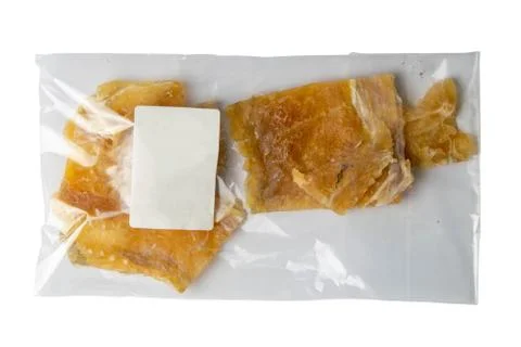 Dried cod fillet in a transparent package appetizer to beer on white backgrou Stock Photos