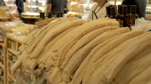 Dried cod in a supermarket stall, with bottles of olive oil in background. Stock Footage 130556768