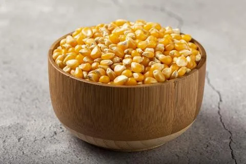 Dried corn. Raw corn for popcorn on the table. Stock Photos