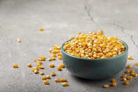 Dried corn. Raw corn for popcorn on the table. Stock Photos