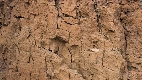 Dried, cracked clay wall showing detailed soil erosion and a rich brown texture Stock Footage 337798947