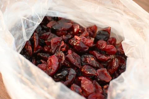 Dried Cranberries in Plastic Bag Close-Up, Healthy Snack Concept Fotos Stock