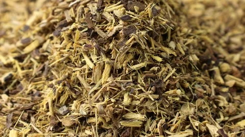 Dried crushed licorice falling down close up Stock Footage 306047684