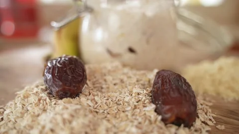 Dried Date Fall into Pile of Oat Flakes, Selective Focus with Copy Space Stock Footage 151286221