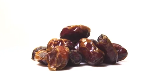 Dried date fruit rotates on a white background around its axis.Arabic food Stock Footage 165474397