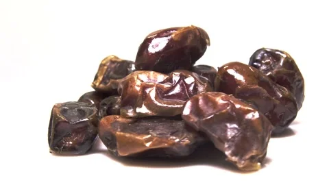 Dried date fruit rotates on a white background around its axis.Arabic food Stock Footage 165474415