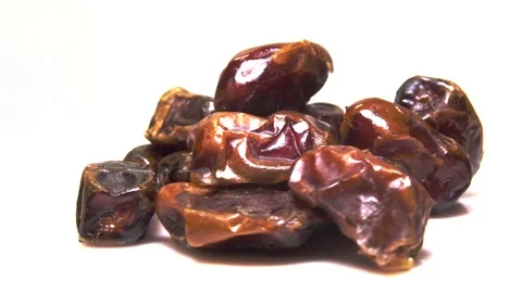 Dried date fruit rotates on a white background around its axis.Arabic food Stock Footage 165474542