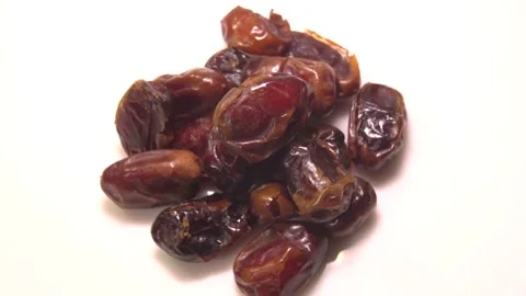 Dried date fruit rotates on a white background around its axis.Arabic food Stock Footage 165475485