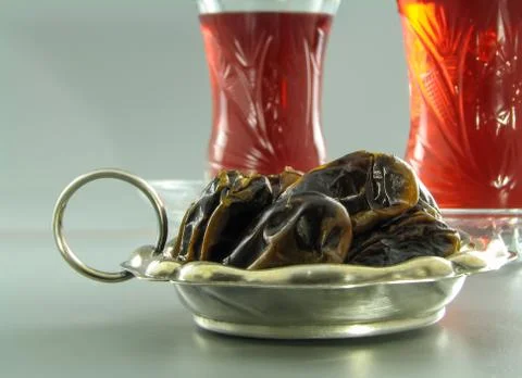Dried dates and karkade tea in armudu glasses close-up Stock Photos