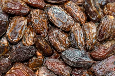 Dried dates background. Fresh arabic dates. Dried date fruit pattern. Stock Photos