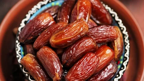 Dried dates in bowl close up. Ramadan Kareem and iftar muslim food. Boom shot Stock Footage 236796204
